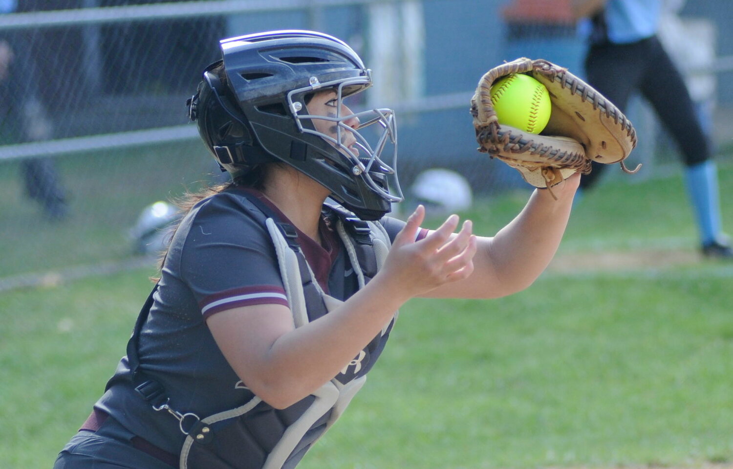 Special delivery. Manor’s catcher, Jocelyn Mills, reels in Carlson’s pitch.